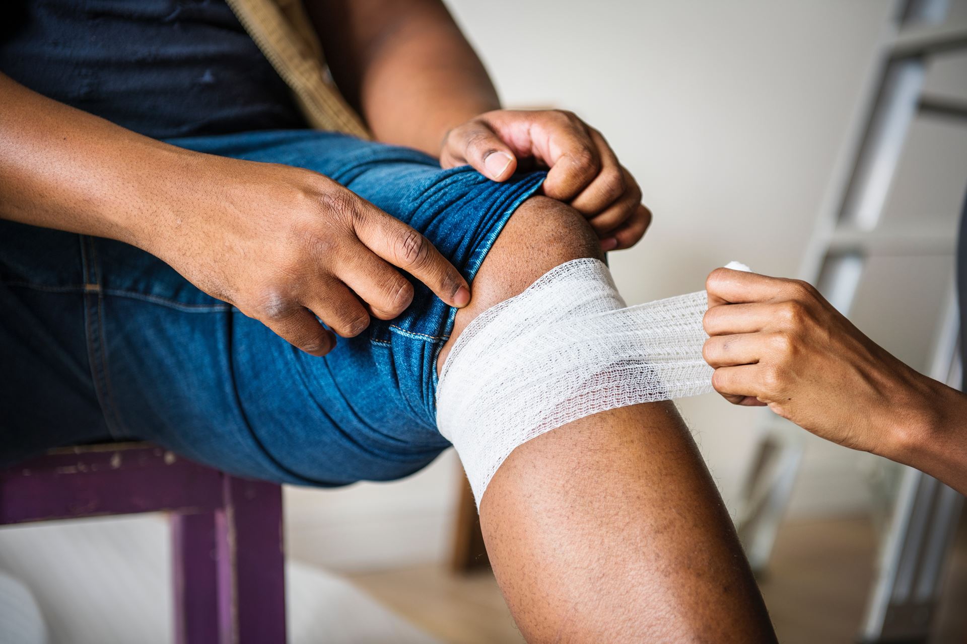 a person having their knee bandaged 
