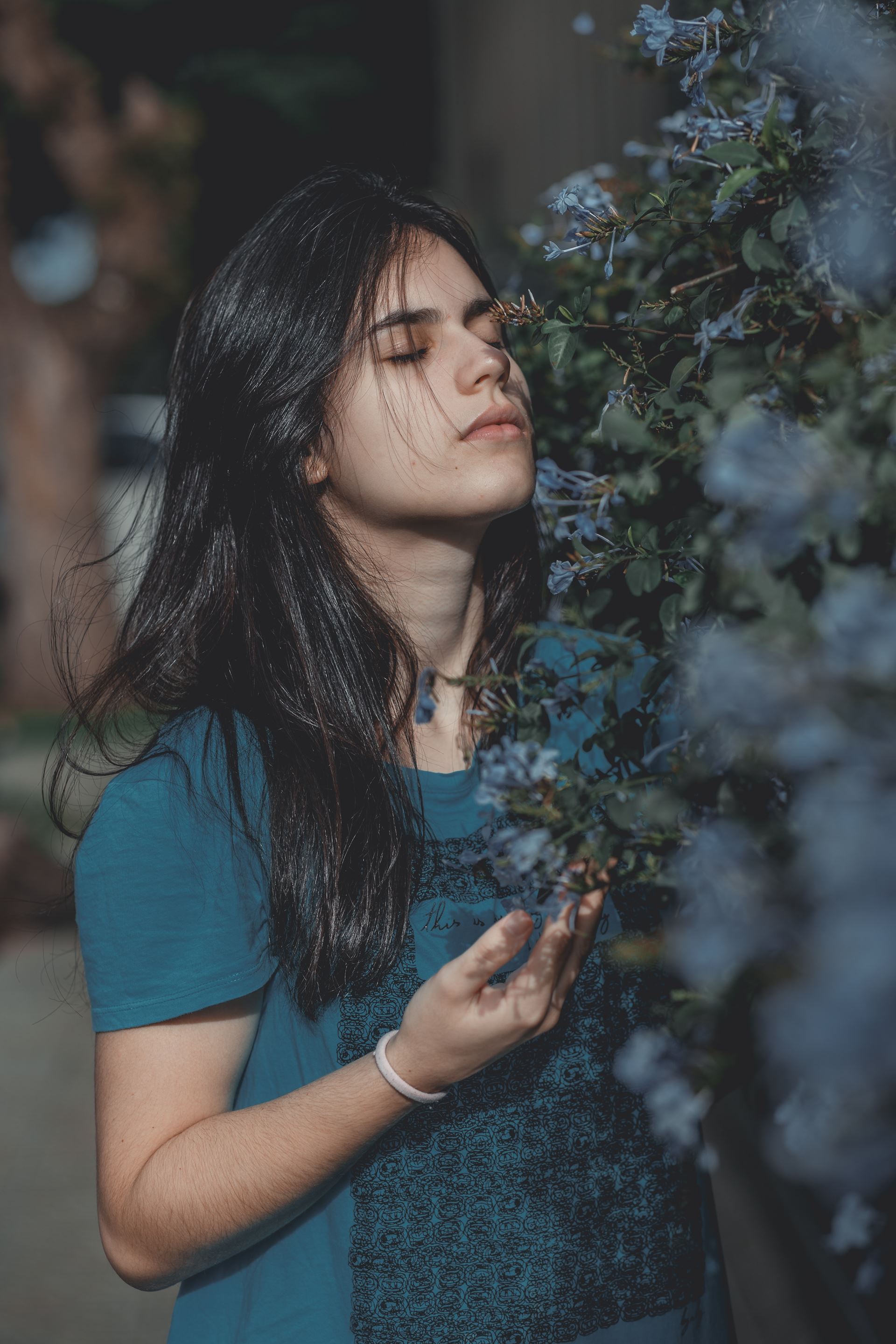 a woman smelling a flower